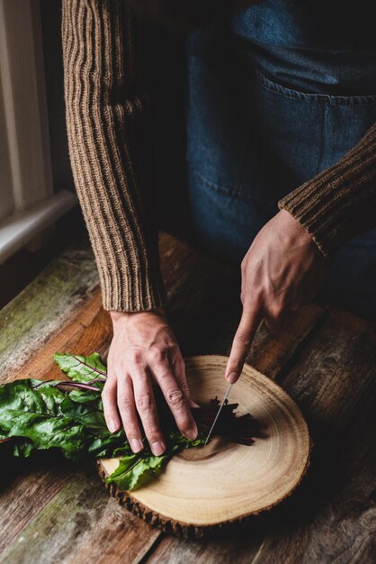Closeup of hands chopping herbs